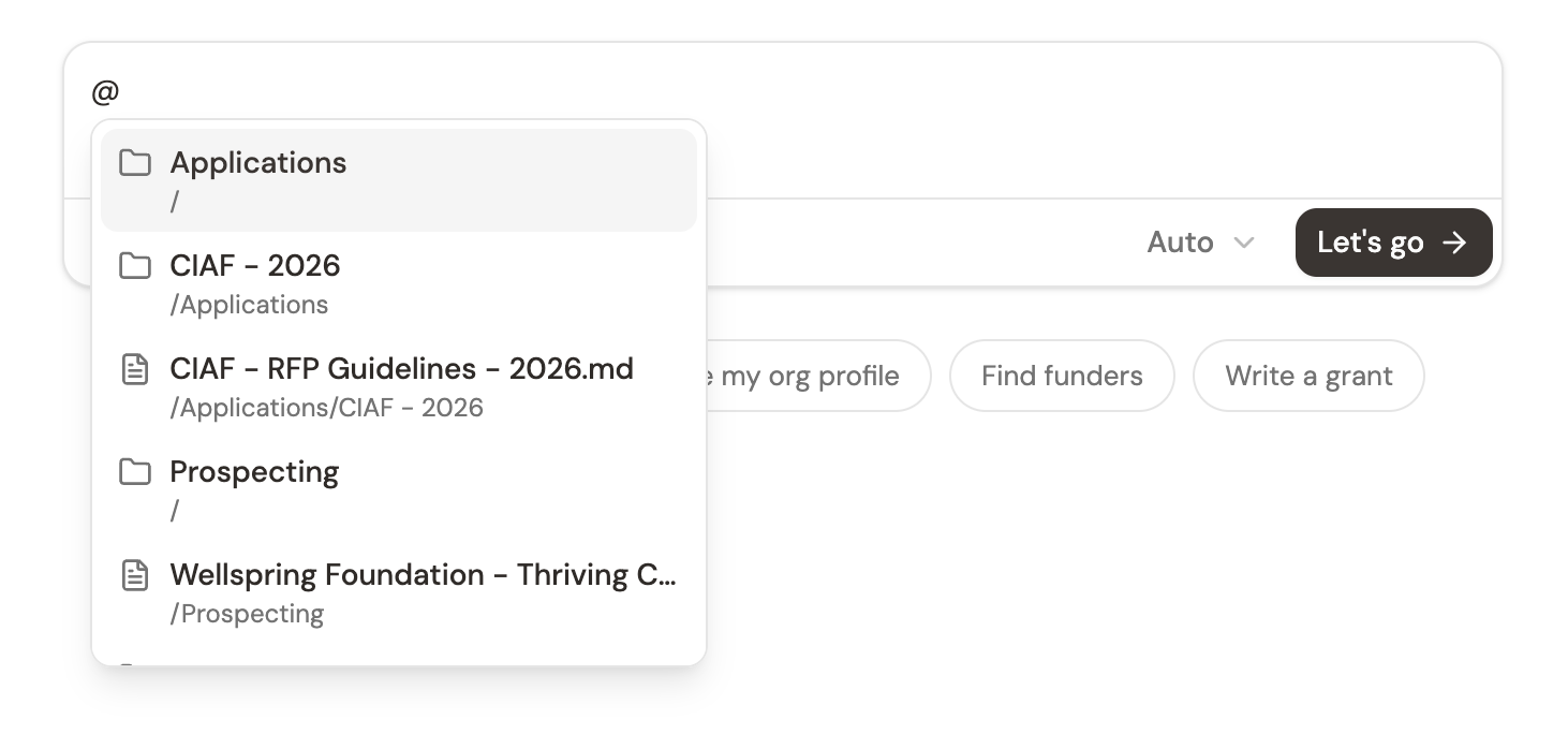 The @ picker showing workspace files and folders you can reference in your message
